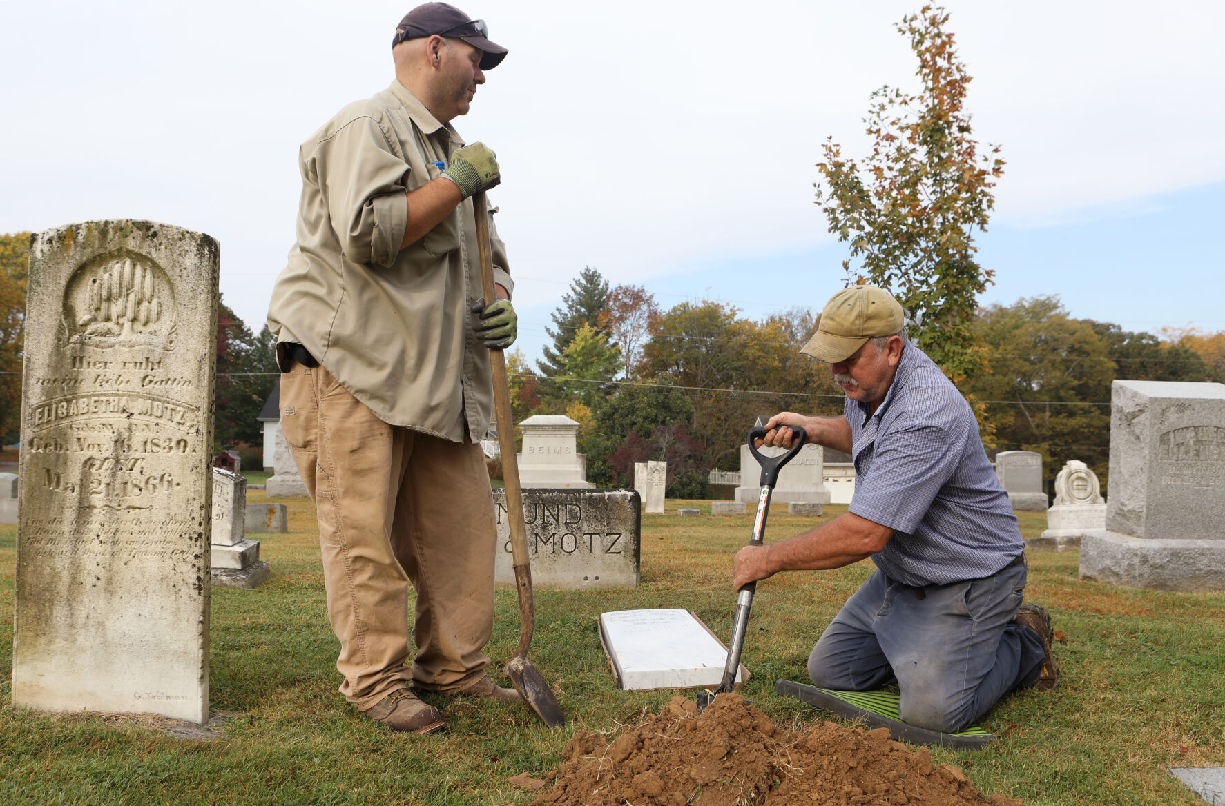 Nathaniel Pfitzinger and Bob Scott dig a hole